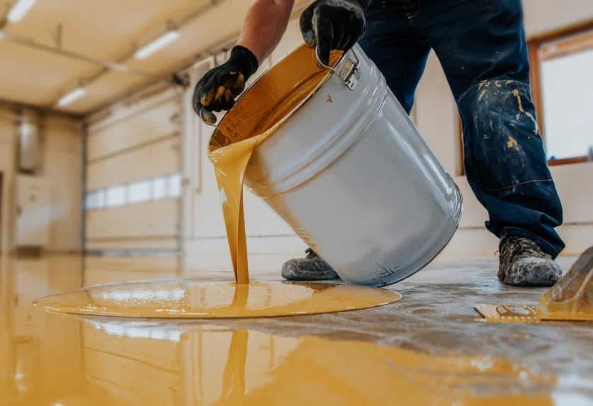 Commercial epoxy floor coating being poured